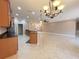 Open floor plan showcasing the kitchen island, pendant lights, and tile floors at 4577 Back Nine Dr, Winter Haven, FL 33884