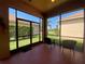 Screened-in lanai with views of the manicured backyard at 4577 Back Nine Dr, Winter Haven, FL 33884