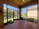Enclosed porch area with views of the manicured yard at 4577 Back Nine Dr, Winter Haven, FL 33884