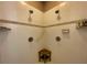 Tiled shower with dual shower heads, corner seat, grab bar, and built-in shelving at 4577 Back Nine Dr, Winter Haven, FL 33884
