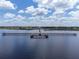 Aerial view of a long pier extending over calm water at 6168 Arborea Dr, Lake Wales, FL 33898