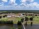 Aerial view of golf course, clubhouse, and pond at 6168 Arborea Dr, Lake Wales, FL 33898