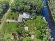 Expansive property with a pool, dock, and lush greenery, creating a private retreat by the water at 6168 Arborea Dr, Lake Wales, FL 33898