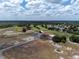 Aerial view of golf course clubhouse, parking lot, and surrounding landscape at 6168 Arborea Dr, Lake Wales, FL 33898