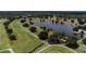 Aerial view of a golf course with a pond and golfer on cart at 6168 Arborea Dr, Lake Wales, FL 33898