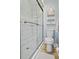 Small bathroom with shower, toilet, and floating shelf at 6168 Arborea Dr, Lake Wales, FL 33898