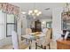 Bright dining room features a glass table, four chairs, and a window with floral curtains at 6168 Arborea Dr, Lake Wales, FL 33898