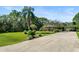 Long driveway leading to a single-story home at 6168 Arborea Dr, Lake Wales, FL 33898