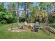 Peaceful fire pit area with wooded backdrop at 6168 Arborea Dr, Lake Wales, FL 33898