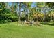 Relaxing fire pit area surrounded by trees at 6168 Arborea Dr, Lake Wales, FL 33898