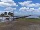 Lakefront community with a pier and grassy area at 6168 Arborea Dr, Lake Wales, FL 33898