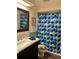 Clean bathroom with dark vanity and geometric shower curtain at 680 Augusta Rd, Winter Haven, FL 33884