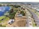 Expansive aerial view showcasing a lakeside home with solar panels and nearby community at 1396 Lucerne Loop Ne Rd, Winter Haven, FL 33881