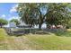 Fenced backyard with a playhouse and views of a gorgeous lake at 1396 Lucerne Loop Ne Rd, Winter Haven, FL 33881