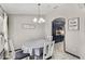 Cozy dining area with a round table, modern chandelier, and white wooden chairs, creating a welcoming atmosphere at 1396 Lucerne Loop Ne Rd, Winter Haven, FL 33881