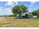 Blue home with extra covered parking and fenced yard near a lake at 1396 Lucerne Loop Ne Rd, Winter Haven, FL 33881
