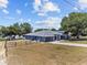 Beautiful blue home with a well-maintained lawn, fenced yard and a lake view at 1396 Lucerne Loop Ne Rd, Winter Haven, FL 33881