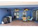 Covered outdoor patio with dining set, grill, and ceiling fans for comfortable entertaining at 1396 Lucerne Loop Ne Rd, Winter Haven, FL 33881