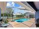 Enclosed pool area with a brick patio and a view of the lake at 1396 Lucerne Loop Ne Rd, Winter Haven, FL 33881