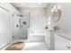 Bright bathroom featuring a glass shower, soaking tub, vanity, and marble tile surround at 6047 Cason Way, Lakeland, FL 33812