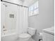 Bright bathroom with a shower/tub combo featuring a mosaic tile accent, and toilet at 6047 Cason Way, Lakeland, FL 33812