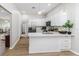 Open-concept kitchen featuring white cabinetry, stainless steel appliances, and pendant lighting at 6047 Cason Way, Lakeland, FL 33812