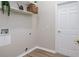 Laundry room with overhead storage shelves and white door at 6047 Cason Way, Lakeland, FL 33812