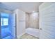 Bright bathroom with a tub and tiled shower, offering a clean and modern bathing experience at 2123 Cartgate Lane, Winter Haven, FL 33884