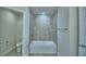 Full bathroom with a shower over tub combo and toilet, offering a clean and modern bathing experience at 2123 Cartgate Lane, Winter Haven, FL 33884