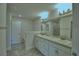 Bright bathroom featuring double sink vanity with granite counters at 2123 Cartgate Lane, Winter Haven, FL 33884