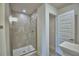 Modern bathroom featuring a glass-enclosed shower with tiled walls and modern fixtures at 2123 Cartgate Lane, Winter Haven, FL 33884