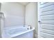 Clean and modern bathroom with a built in tub, perfect for relaxation at 2123 Cartgate Lane, Winter Haven, FL 33884
