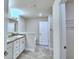 Bright bathroom featuring double sink vanity with granite counters and a linen closet at 2123 Cartgate Lane, Winter Haven, FL 33884