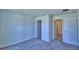 Neutral bedroom showcasing plush carpet, crisp white walls, and convenient access to multiple doorways at 2123 Cartgate Lane, Winter Haven, FL 33884