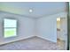Corner bedroom with neutral walls, carpet, and a bright window at 2123 Cartgate Lane, Winter Haven, FL 33884