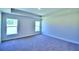 Large primary bedroom with windows and carpet flooring at 2123 Cartgate Lane, Winter Haven, FL 33884