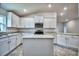 New kitchen with an island, stainless appliances, and white cabinets at 2123 Cartgate Lane, Winter Haven, FL 33884
