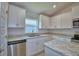 Bright kitchen featuring modern stainless appliances, counter tops, and white cabinets at 2123 Cartgate Lane, Winter Haven, FL 33884