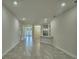 Open living room with tile floors leading to the kitchen at 2123 Cartgate Lane, Winter Haven, FL 33884