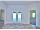 Open living room with double doors to backyard and tile floors at 2123 Cartgate Lane, Winter Haven, FL 33884