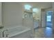 Large main bathroom with a soaking tub, a double vanity, and ceramic tile floors at 2123 Cartgate Lane, Winter Haven, FL 33884