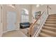 Bright entryway with tile floors, white door, and staircase at 318 Crescent Ridge Rd, Auburndale, FL 33823