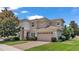 Two-story house with a three-car garage and manicured lawn at 318 Crescent Ridge Rd, Auburndale, FL 33823