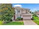 Two story house with a two car garage and manicured lawn at 318 Crescent Ridge Rd, Auburndale, FL 33823