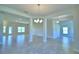 Open concept dining room with tile floors and chandelier at 4081 Tullamore Ln, Auburndale, FL 33823