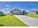 New home exterior with driveway and green lawn at 4081 Tullamore Ln, Auburndale, FL 33823