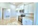 White kitchen cabinets, stainless steel appliances and granite countertops at 4081 Tullamore Ln, Auburndale, FL 33823