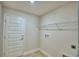 Laundry room with built-in shelving and tile flooring at 4081 Tullamore Ln, Auburndale, FL 33823