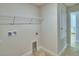 Bright laundry room with tile floor and built-in shelving at 4081 Tullamore Ln, Auburndale, FL 33823