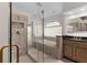 A tiled bathroom features a glass shower and a soaking tub under a decorative window at 5660 Sandpipers Dr, Lakeland, FL 33809